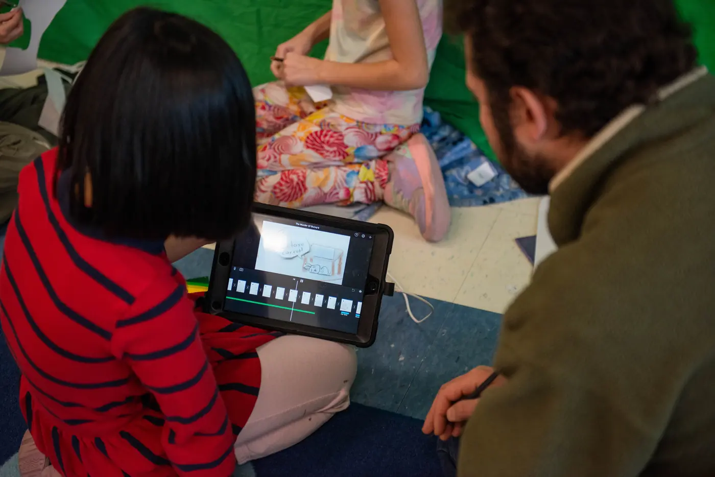 An Athena instructor helping students edit a stop-motion project